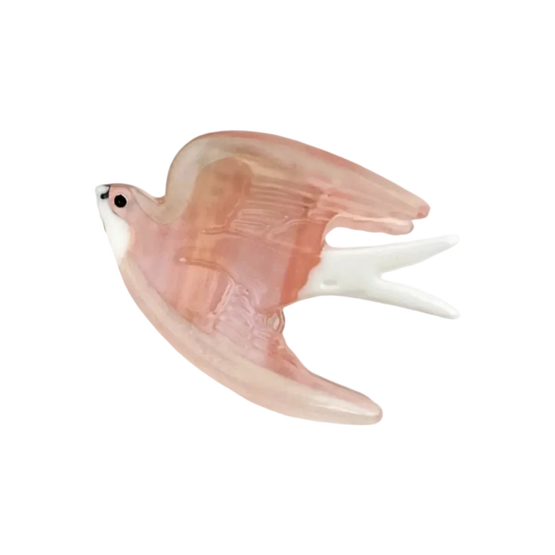 Mini blush pink swallow claw clip with shimmery wings and a white tail.