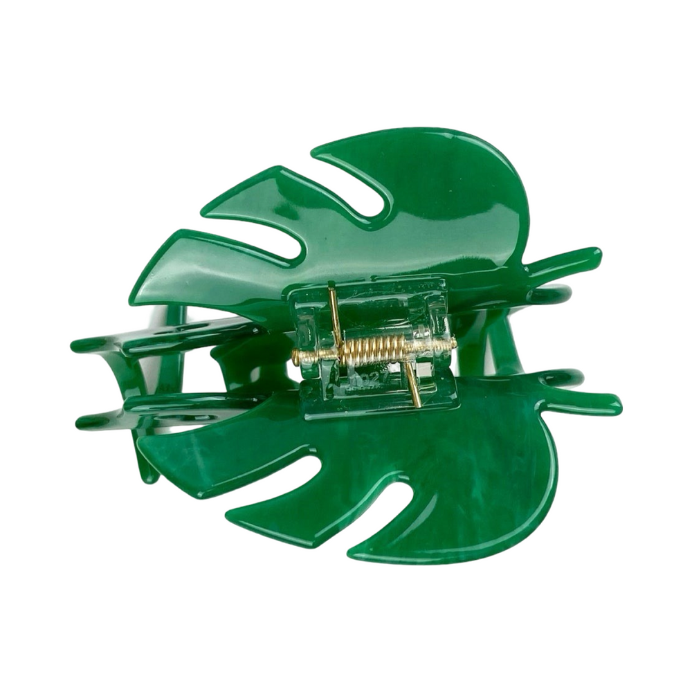 top view of a green monstera hair claw clip