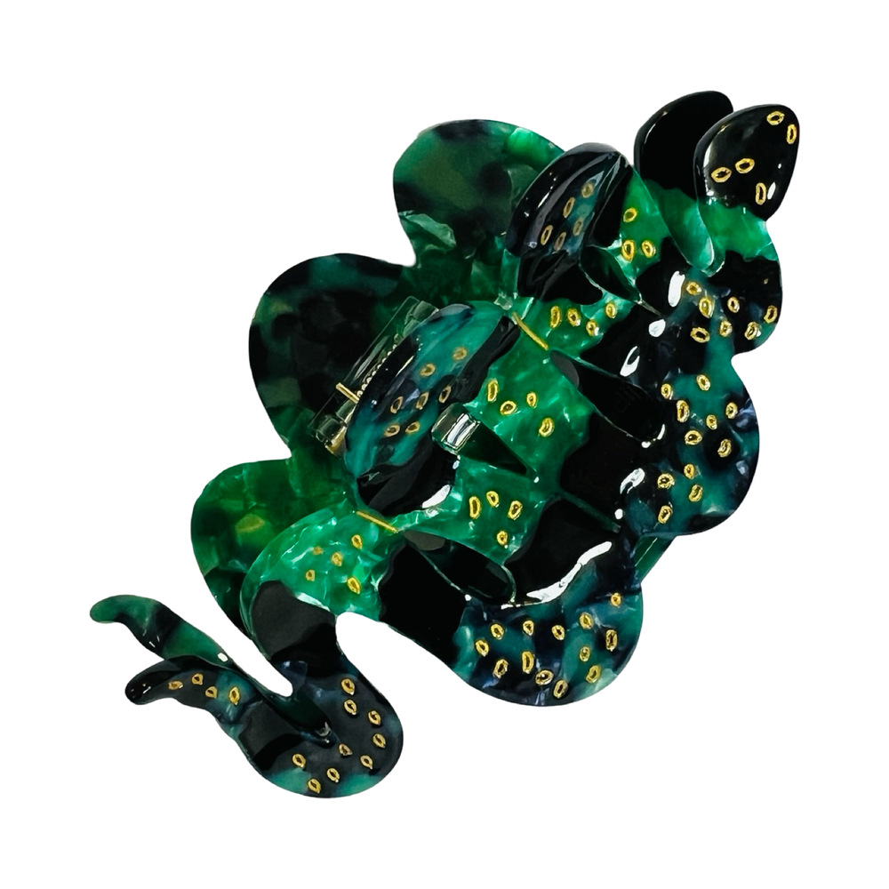 Snake-shaped hair claw clip with green and black patterns, golden accents