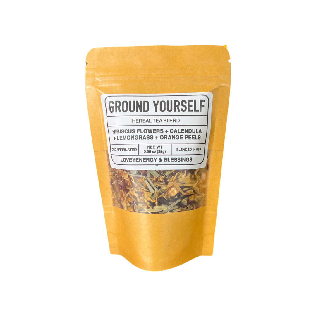 .99 oz  oz kraft pouch of tea featuring dried hibiscus fowers, calendula, lemongrass and orange peels with a white branded label. Brand: Loveyenergy & Blessings