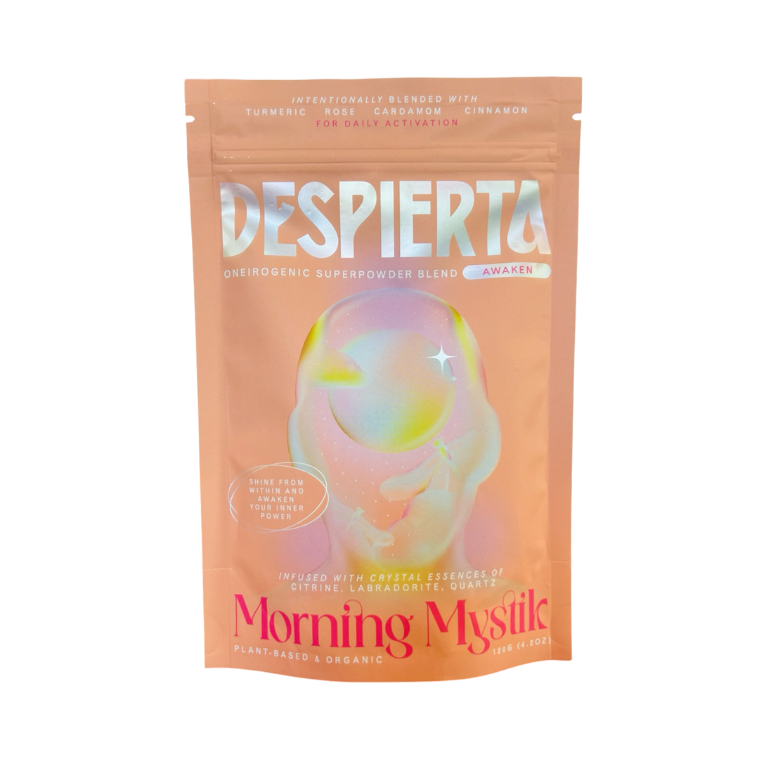 A peach-colored 4.2 oz pouch of Despierta – Morning Mystic oneirogenic superpowder blend. The packaging features a holographic, dreamy design with soft pastel tones and ethereal artwork. 