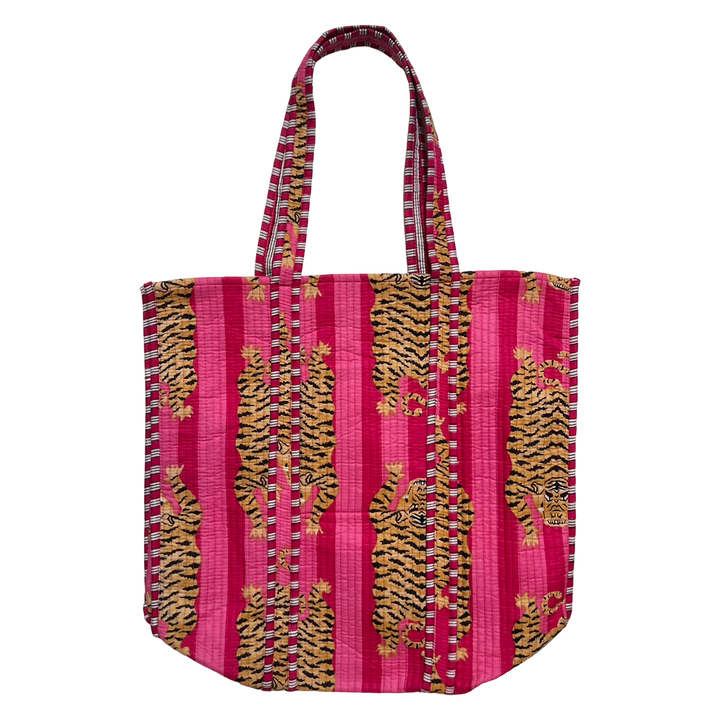 A vibrant quilted tote bag featuring an orange and black tiger print on a pink and dark pink striped background. The bag has two sturdy quilted handles with a matching striped pattern