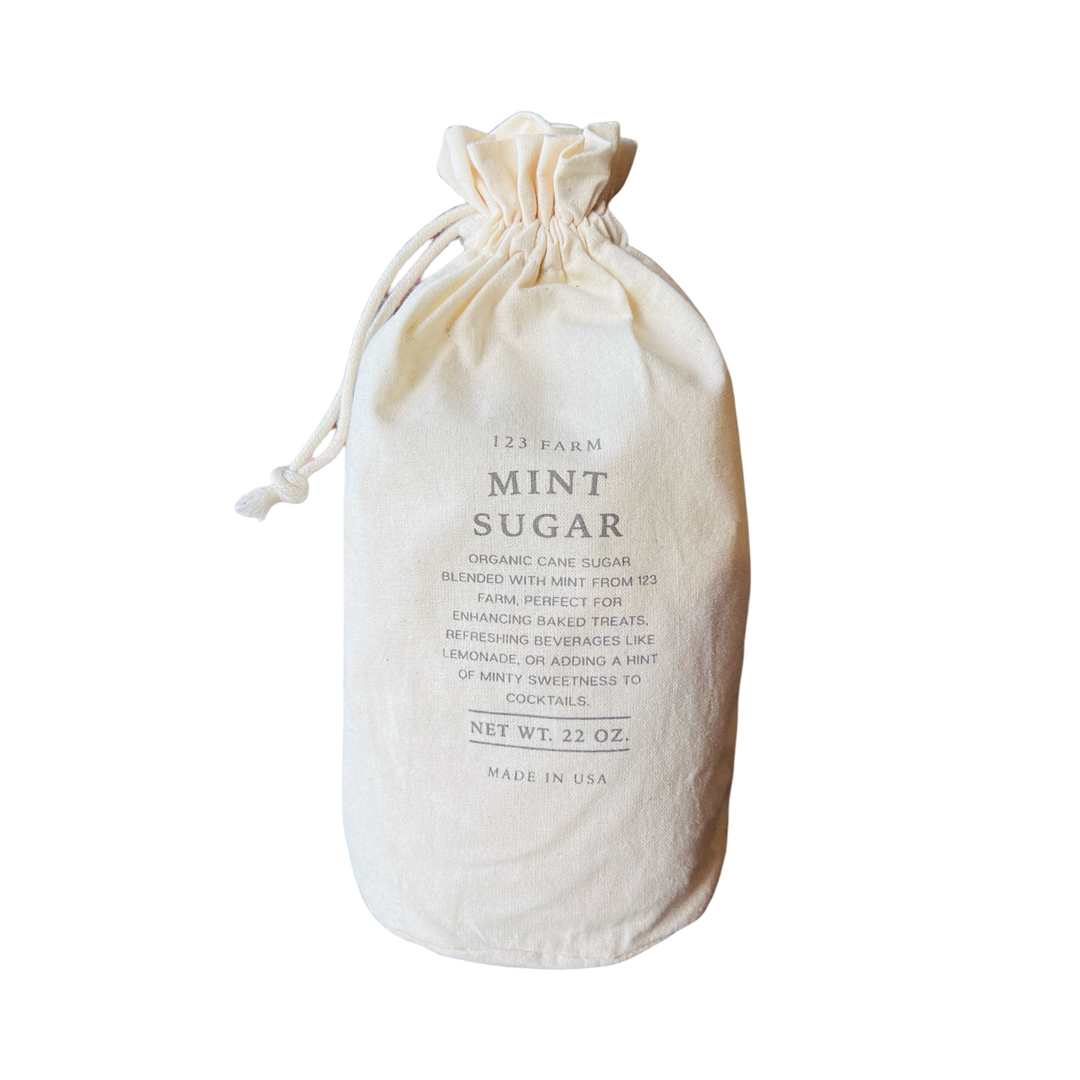 A rustic fabric bag labeled "Mint Sugar" from 123 Farm, featuring organic mint blended with organic cane sugar.