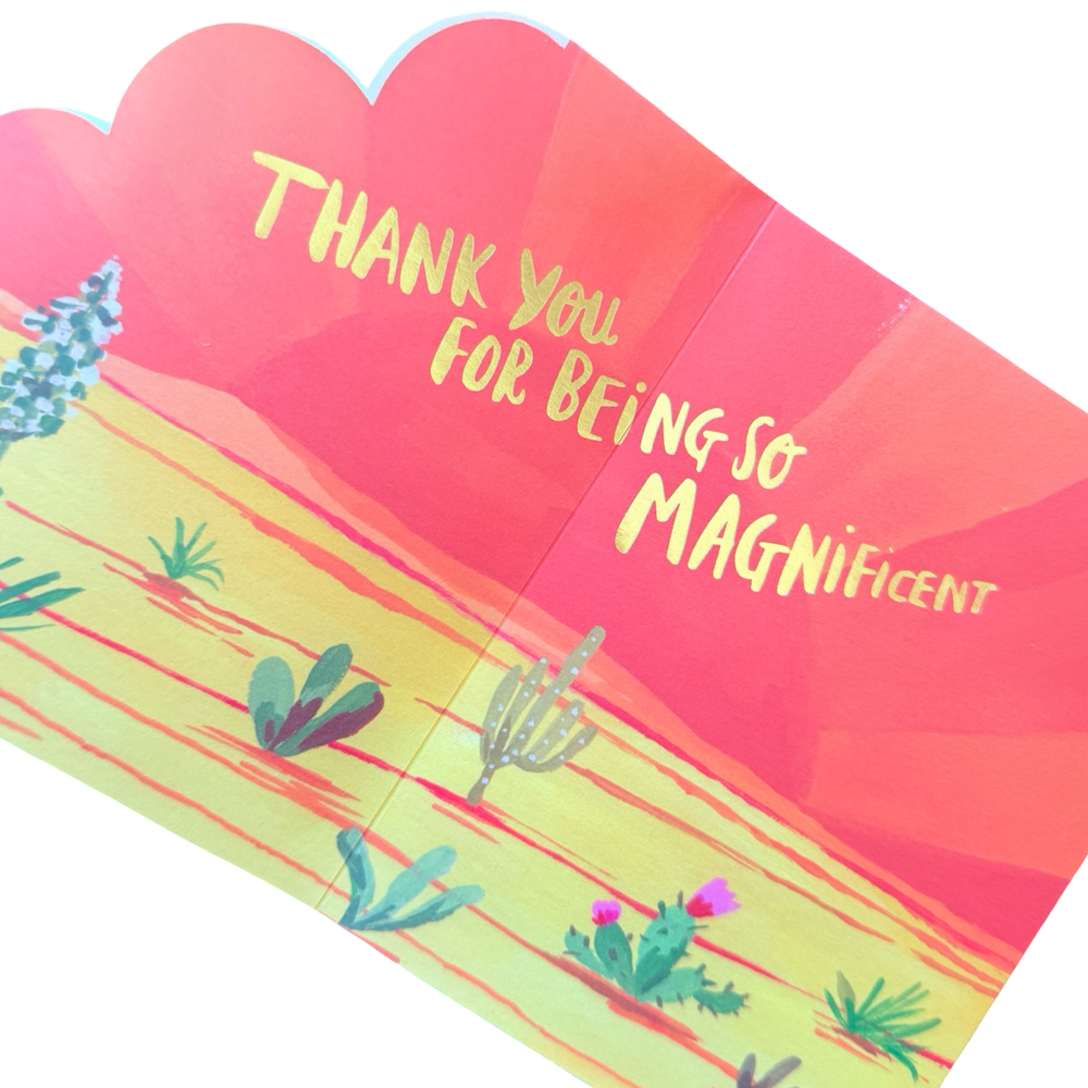 Greeting card interior with a warm desert landscape and the message “Thank you for being so magnificent” in yellow script.