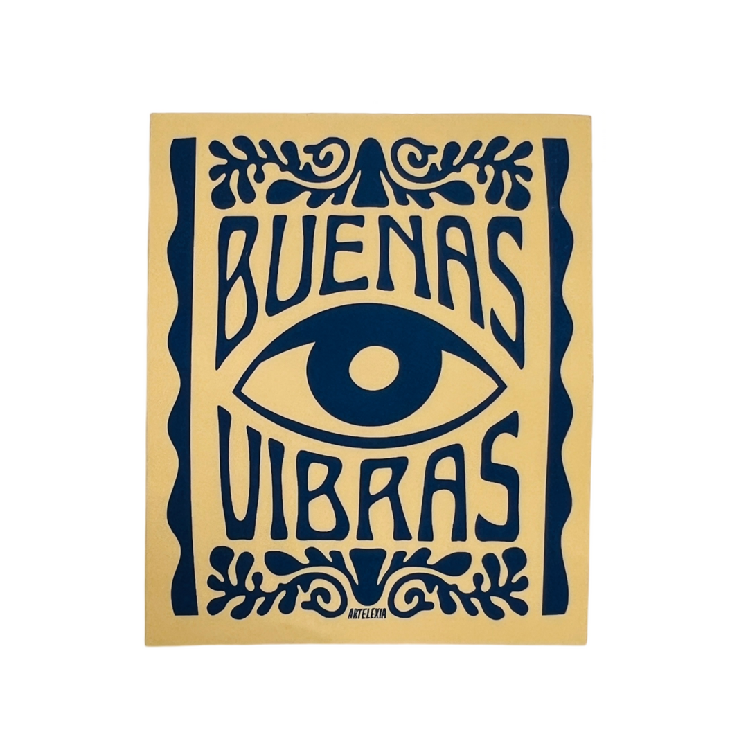 tan rectangle sticker with an image of an eye in the center and the phrase Buenas vibras in navy blue lettering.