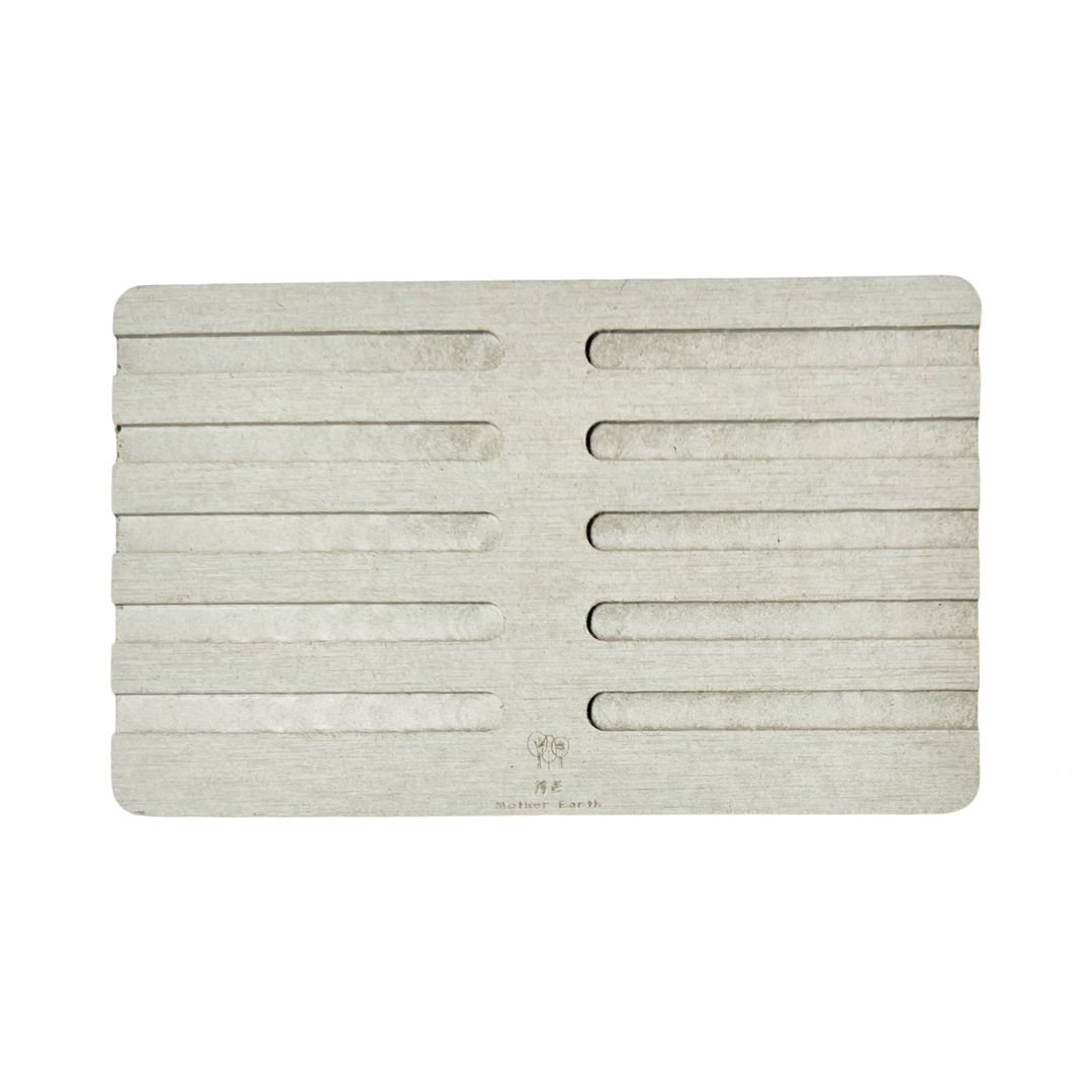 light grey diatomite rectangle soap dish with ridges on the top of it.