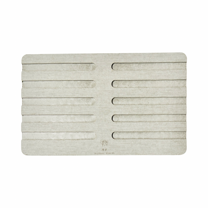 light grey diatomite rectangle soap dish with ridges on the top of it.