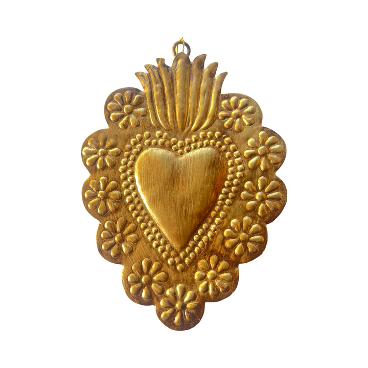 brass colored sacred heart surrounded by a floral design