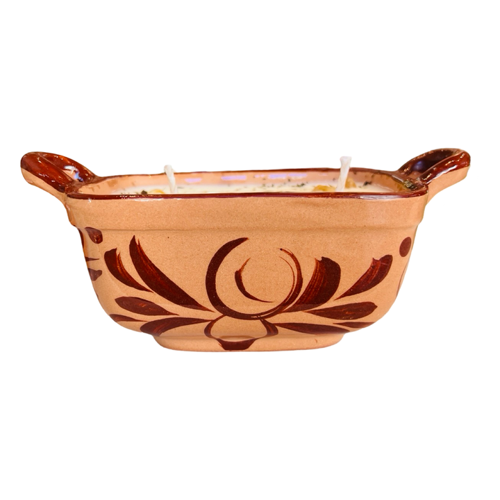 Side view of a brown cazuela vessel that features a dark brown handpainted design and features handles