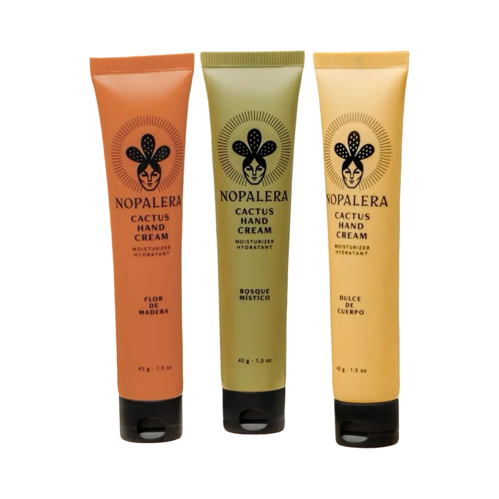 Three Nopalera cactus hand creams in green, cream, and orange tubes labeled Bosque Místico, Dulce de Cuerpo, and Flor de Madera.