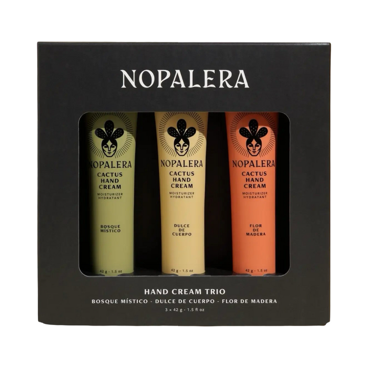 Black gift box containing three Nopalera cactus hand creams in green, cream, and orange tubes labeled Bosque Místico, Dulce de Cuerpo, and Flor de Madera.