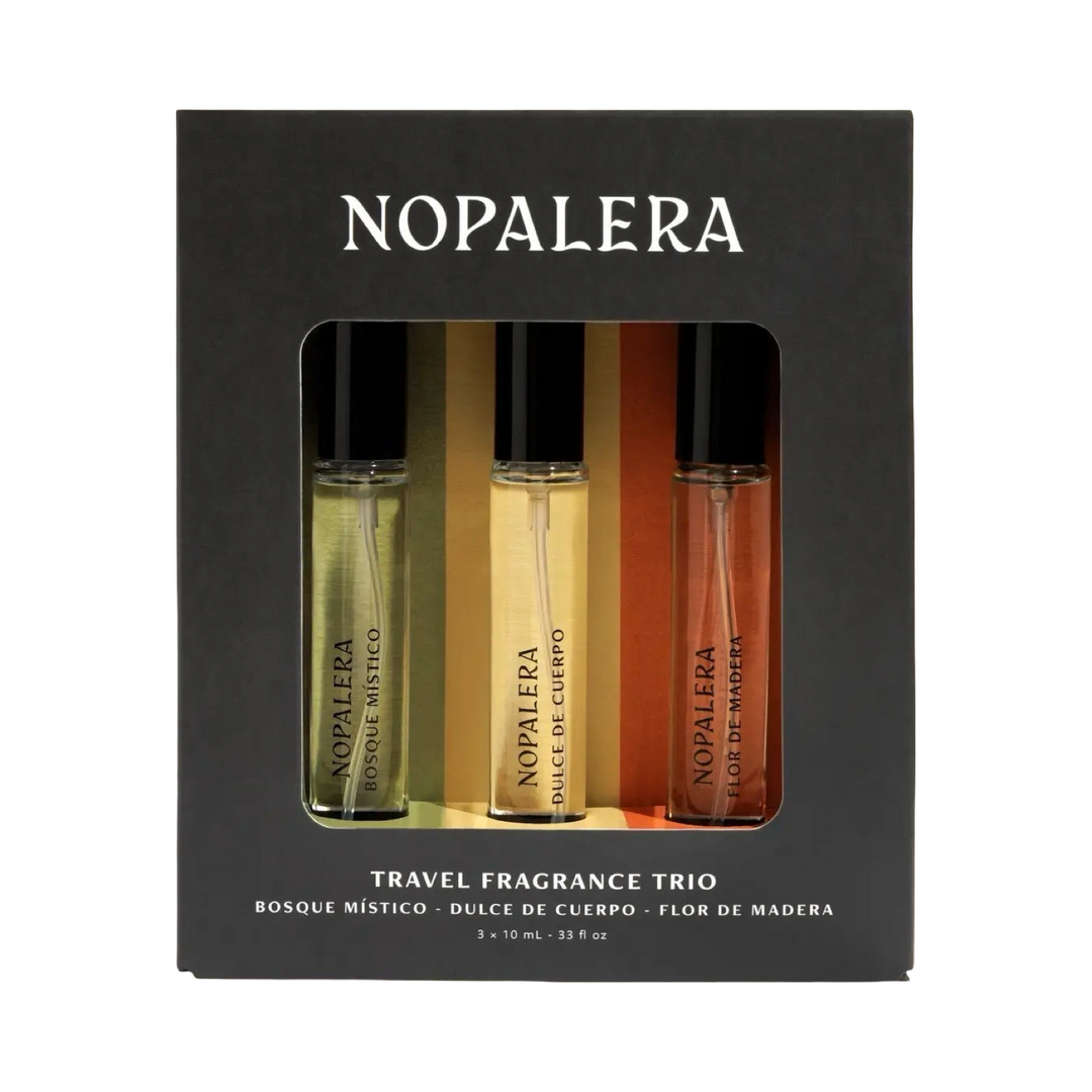 Black gift box containing three Nopalera travel fragrance bottles in green, yellow, and orange, labeled Bosque Místico, Dulce de Cuerpo, and Flor de Madera.