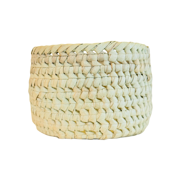 A round handwoven natural palm leaf basket
