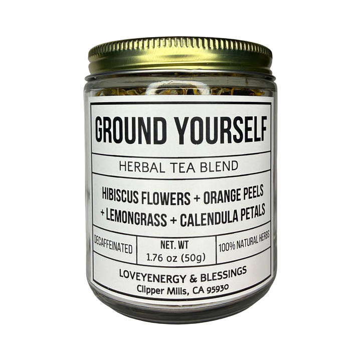 a clear 1.76 oz jar of ground yourself herbal tea with a gold lid. Features hibiscus flowers, orange peels, lemongrass and calendula petals.