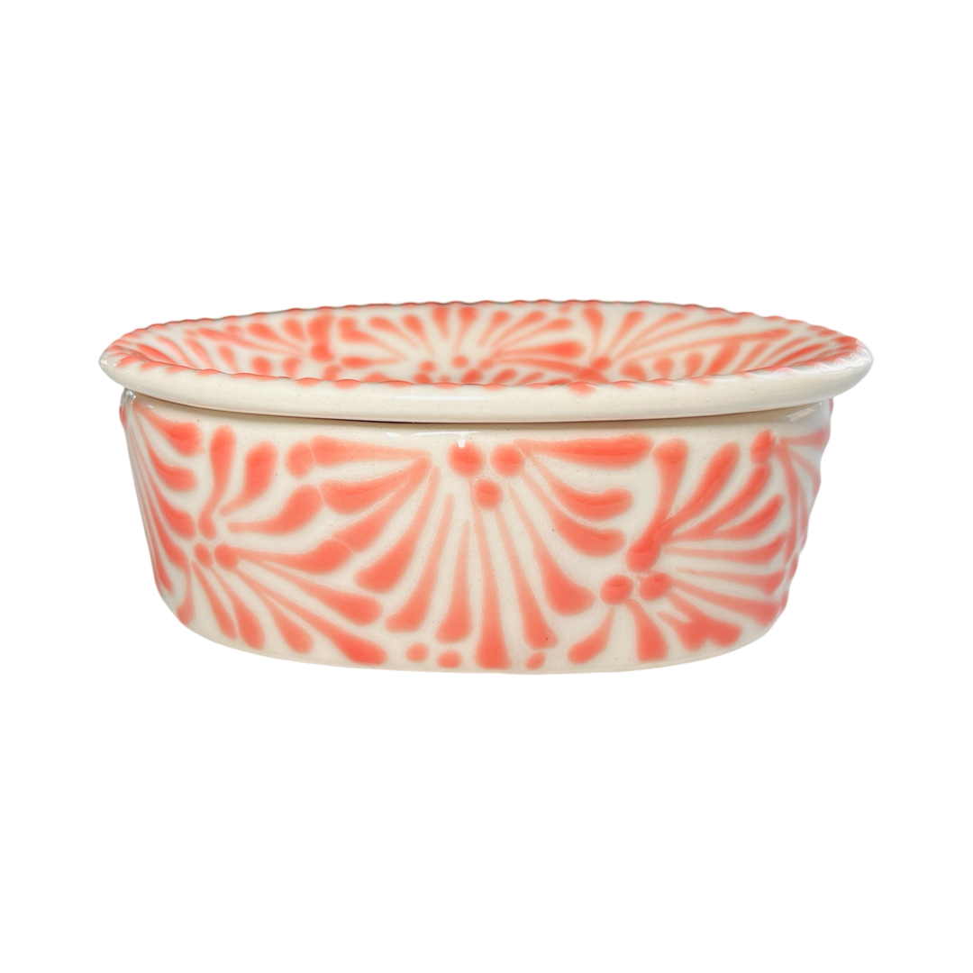 side view of a Puebla soap dish with a white and coral glazed design.