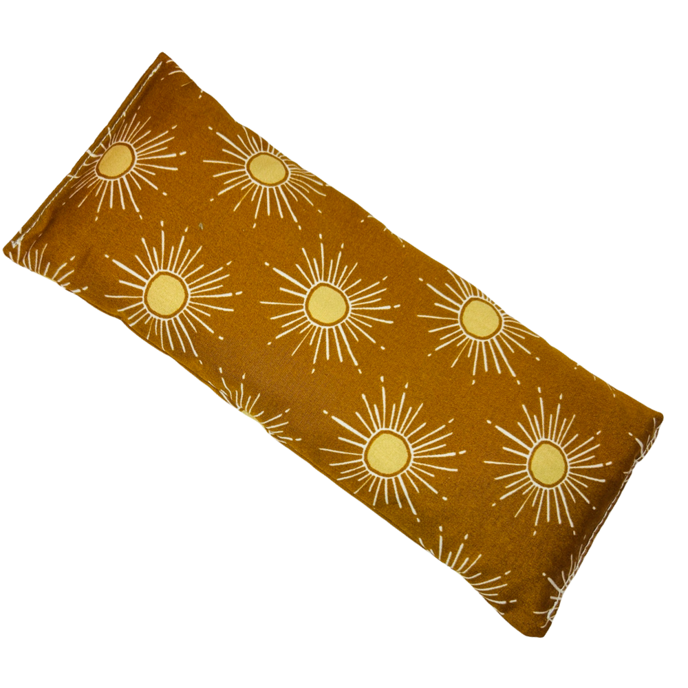 golden rectangle eye pillow with a sun design