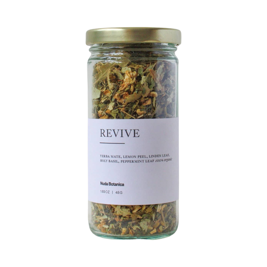 1.69 oz clear jar of dried flowers and herbs tea with a white branded label with white lettering. Brand: Nuda Botanica