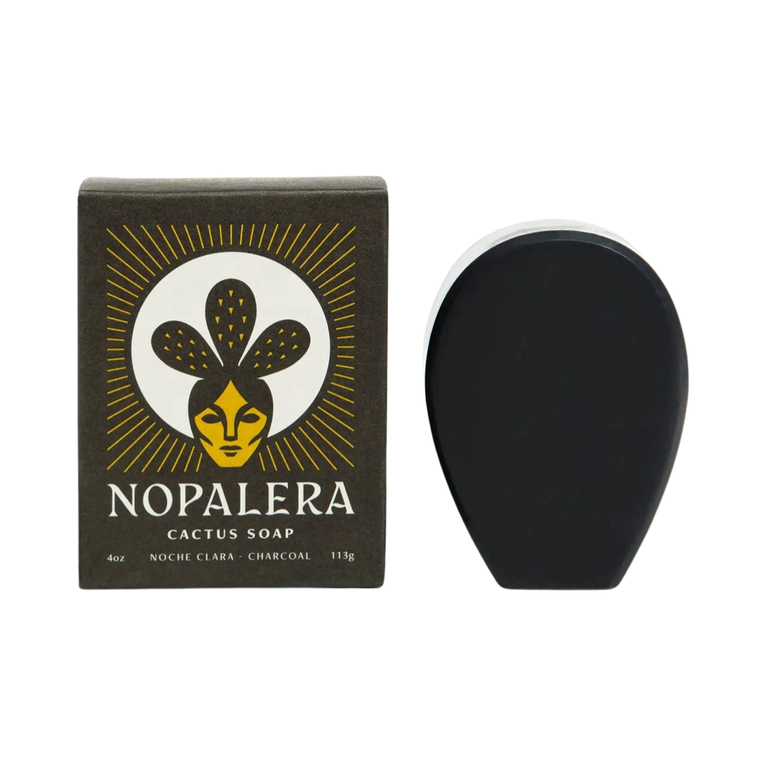 black colored branded box of cactus soap on the side of a black cactus shaped bar of soap. Brand: Nopalera