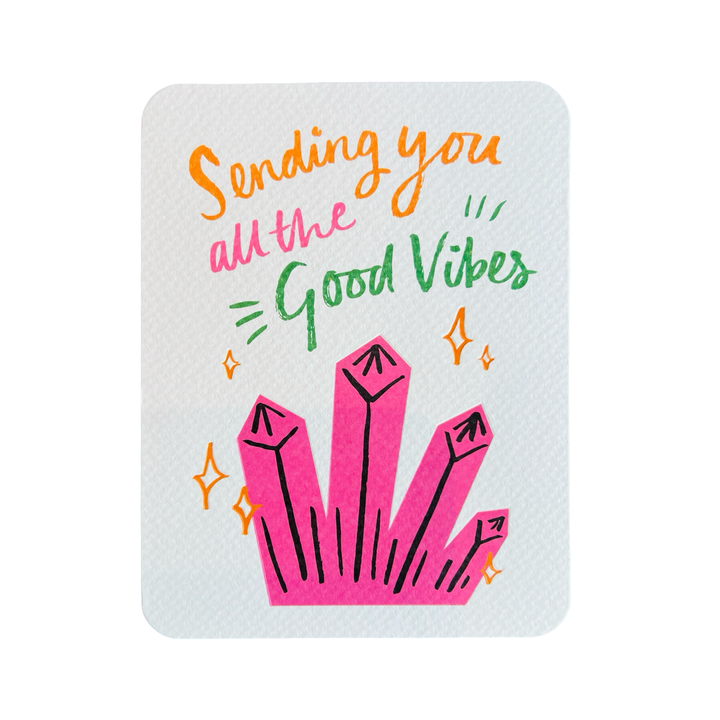 white card with an illustration of pink crystals and the phrase Sending You All The Good Vibes in orange, green and pink lettering