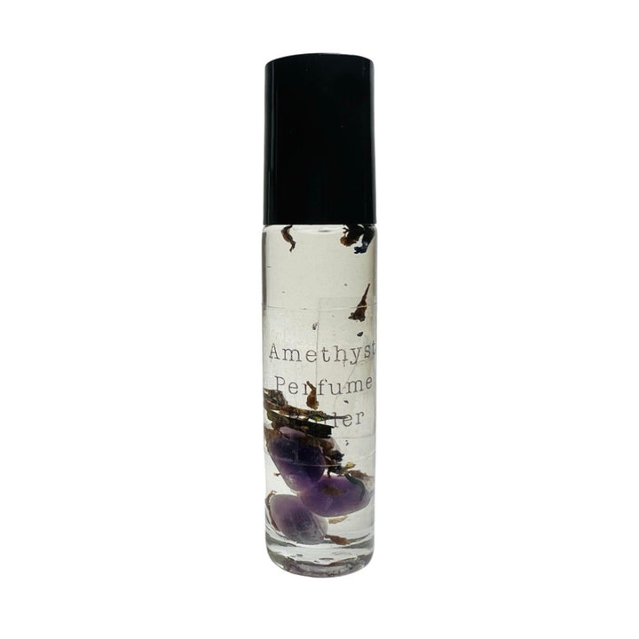 clear glass tube of perfume oil with amethyst stones