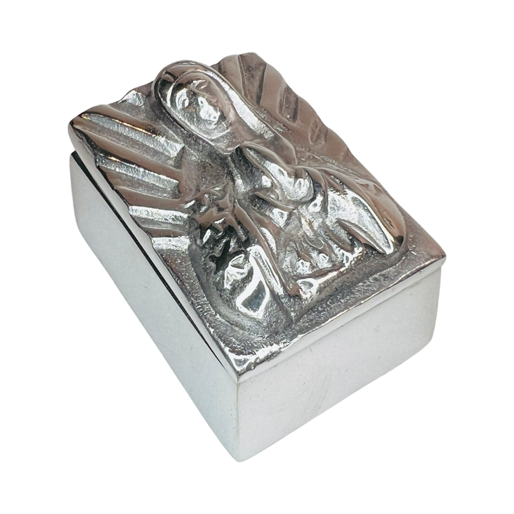 Side view of a pewter trinket box with an image of Our Lady of Guadalupe