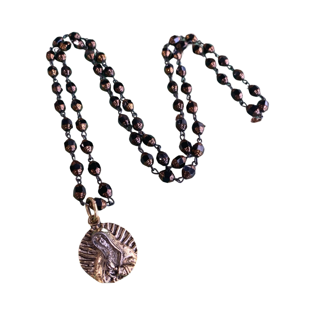a brown Czech bead necklace with a brass Our Lady of Guadalupe pendant