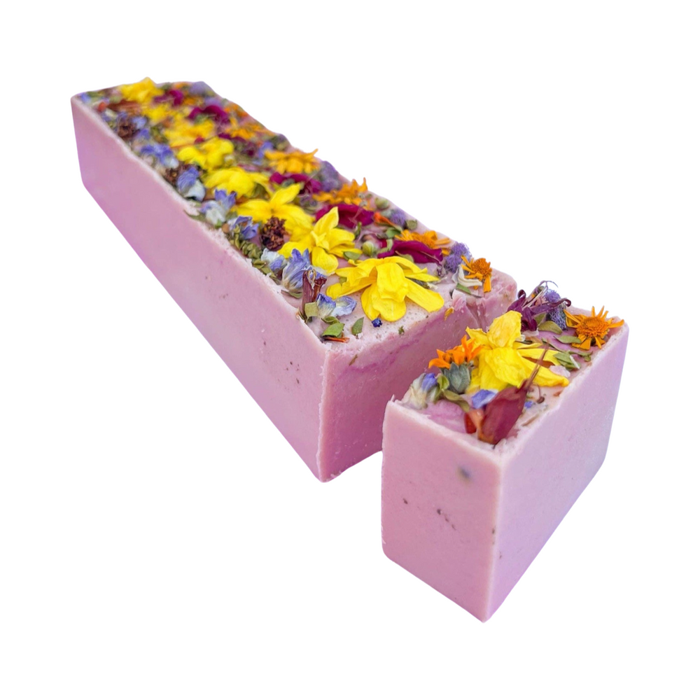 a block of soap with one bar cut out and features dried flowers on the top