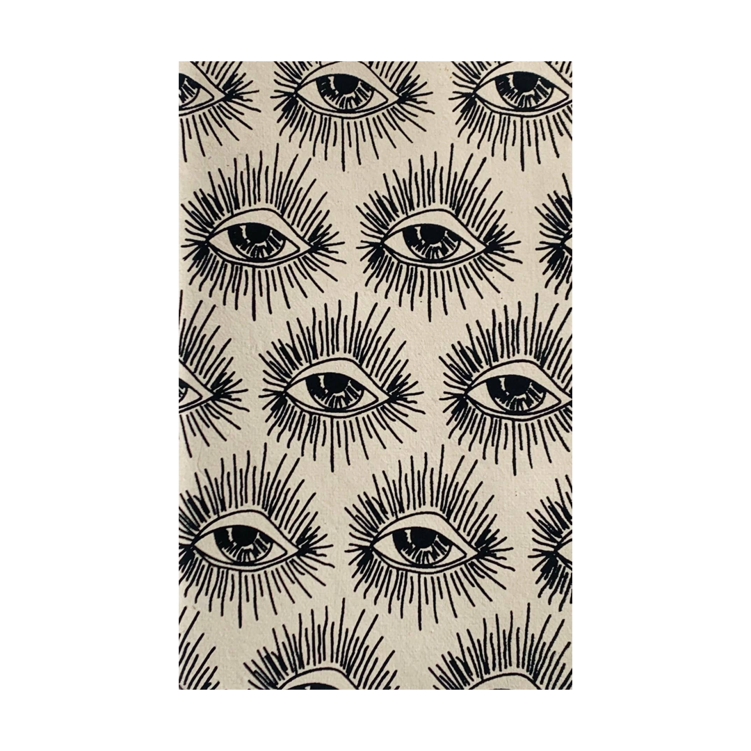 Cream notebook featuring a black evil eye repeated pattern