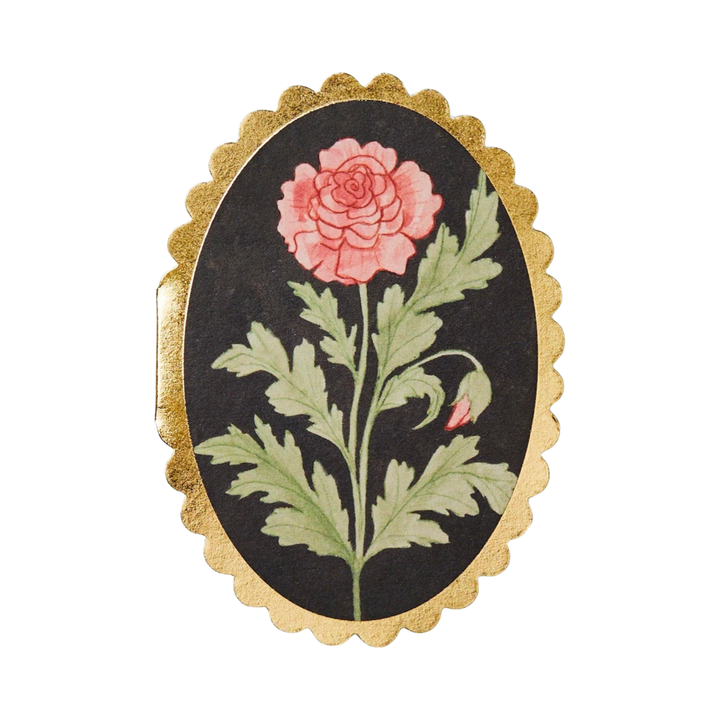 oval black card with a gold scalloped edge featuring a red rose in the center