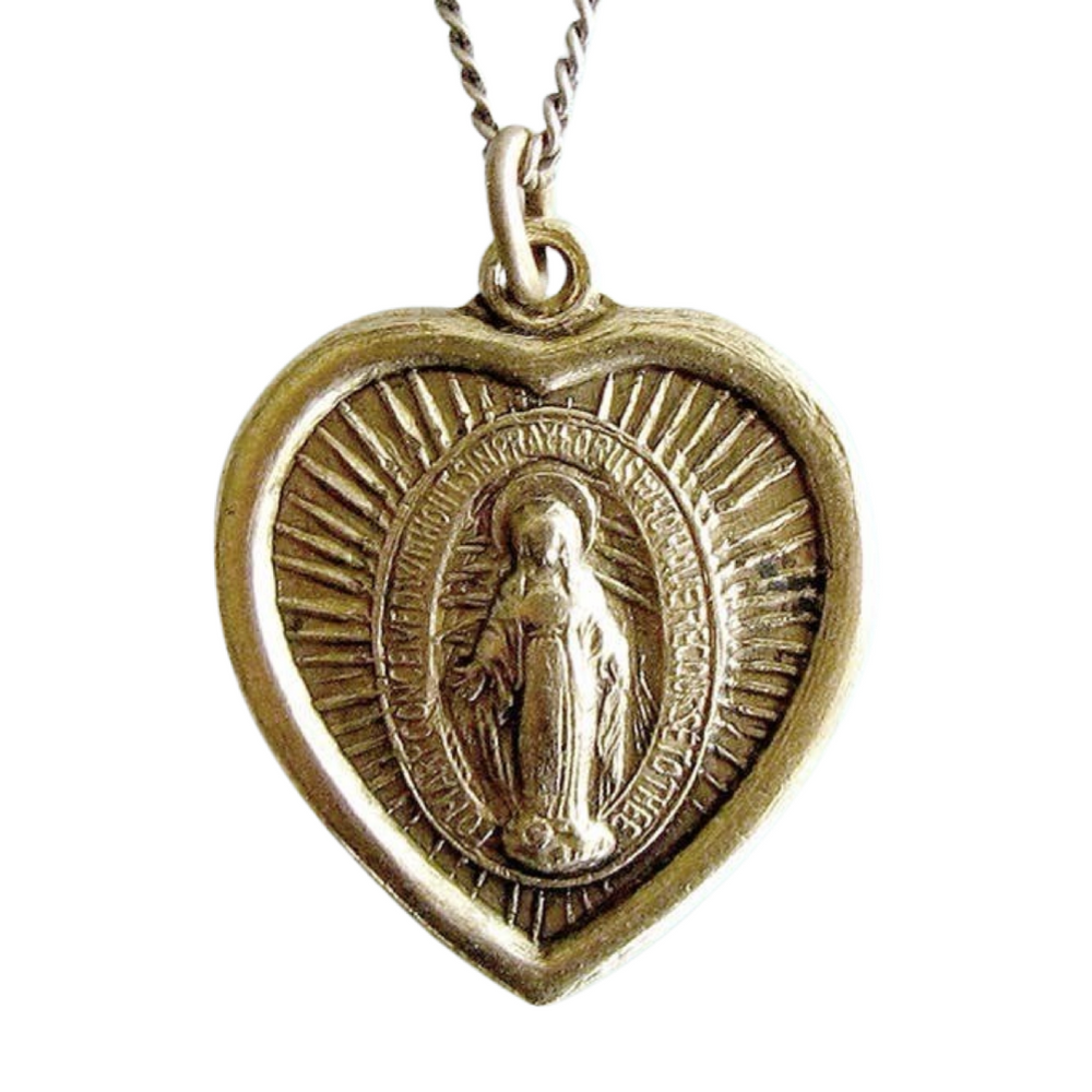 close up view of a gold necklace with a heart shaped pendant with an image of the Virgin Mary