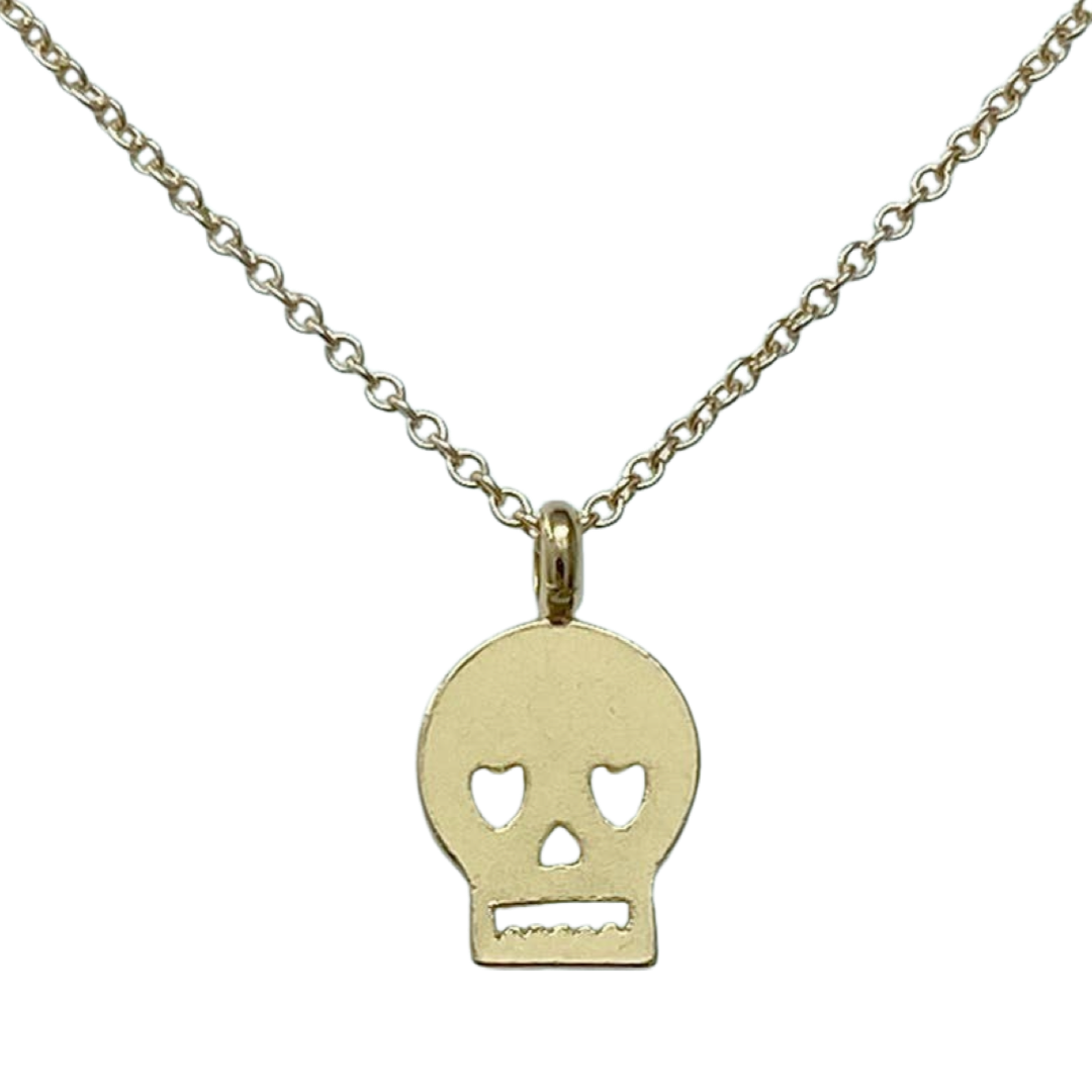 gold necklace with a skull shaped pendant