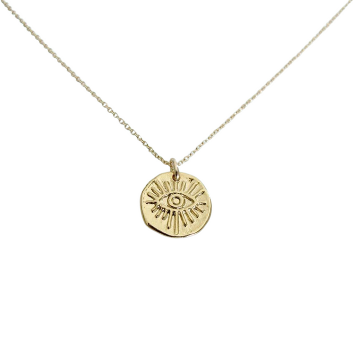 gold medallion with an image of an eye on a gold chain