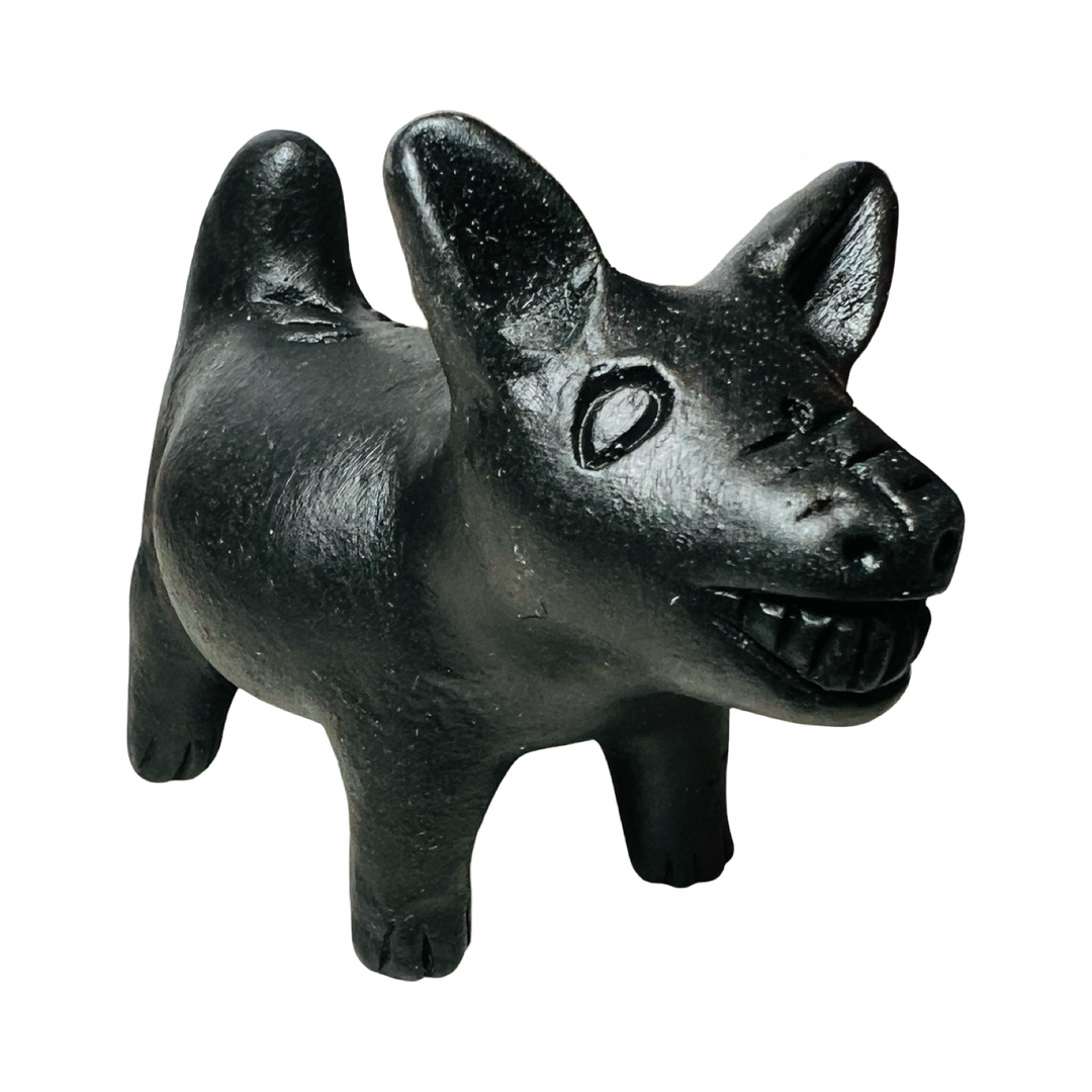 side view of a black clay dog figurine