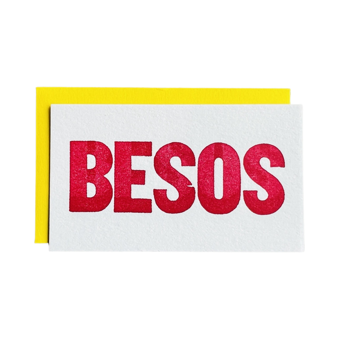 white mini card with a yellow envelope and the word Besos in red lettering