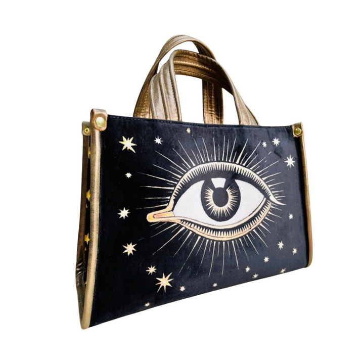 black  hand bag with an image of an eye with sunbursts and sun rays. Brand: La Funky Mexicana