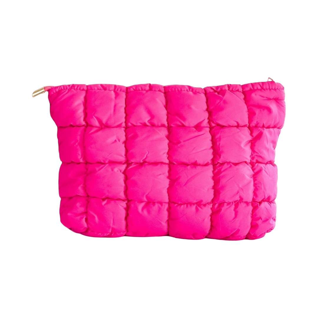 Quilted puffer makeup bags in hot pink with a textured, padded exterior.