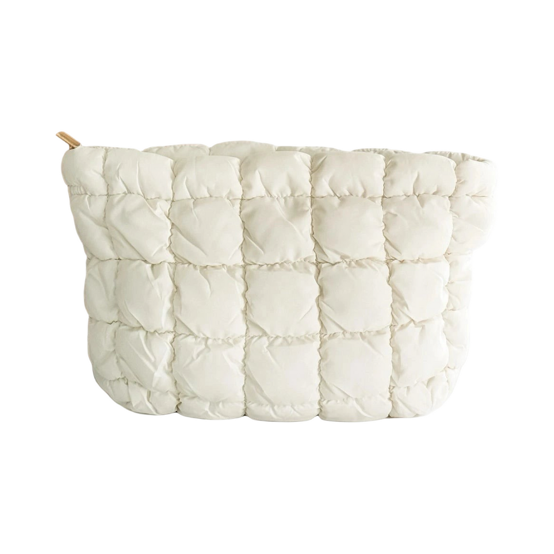 Quilted puffer makeup bags in white with a textured, padded exterior.