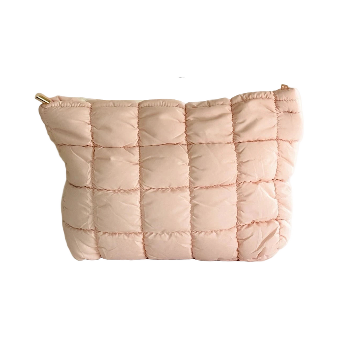 Quilted puffer makeup bags in light pink with a textured, padded exterior.