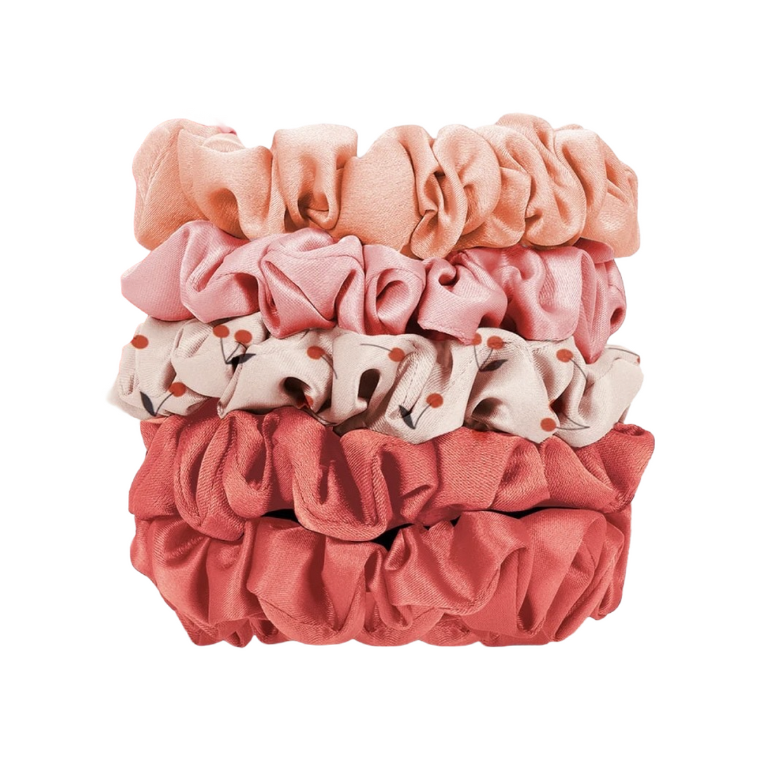 Set of five ruched satin scrunchies in coordinated cherry blossom–inspired colors and patterns,stacked.