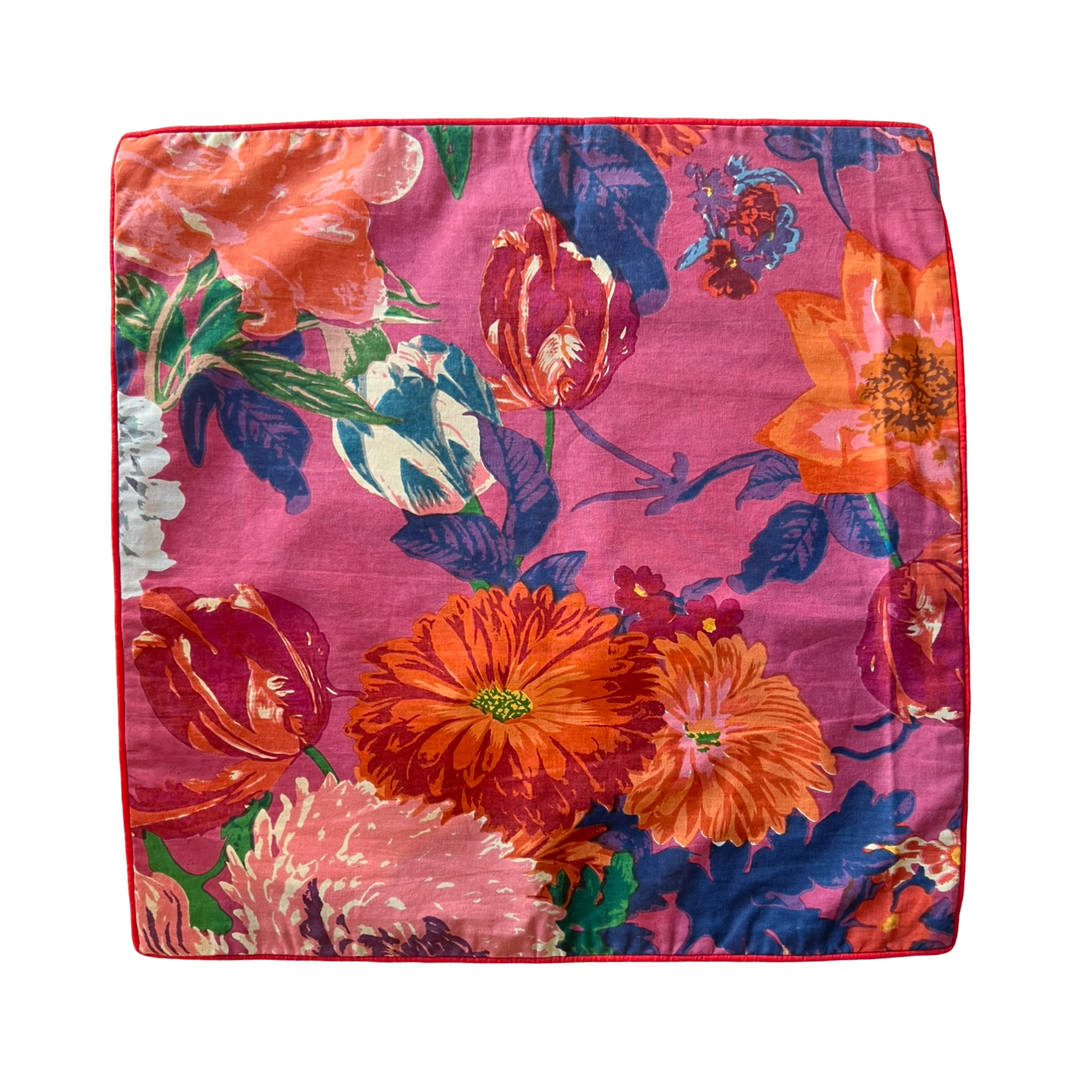 Pink square pillow cover with a floral design.