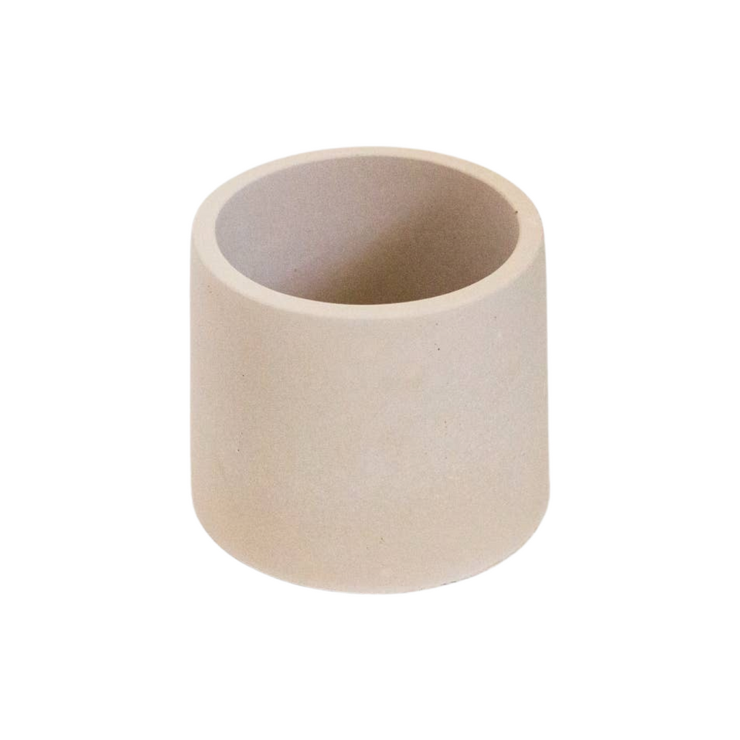 Beige cylinder shaped candle vessel