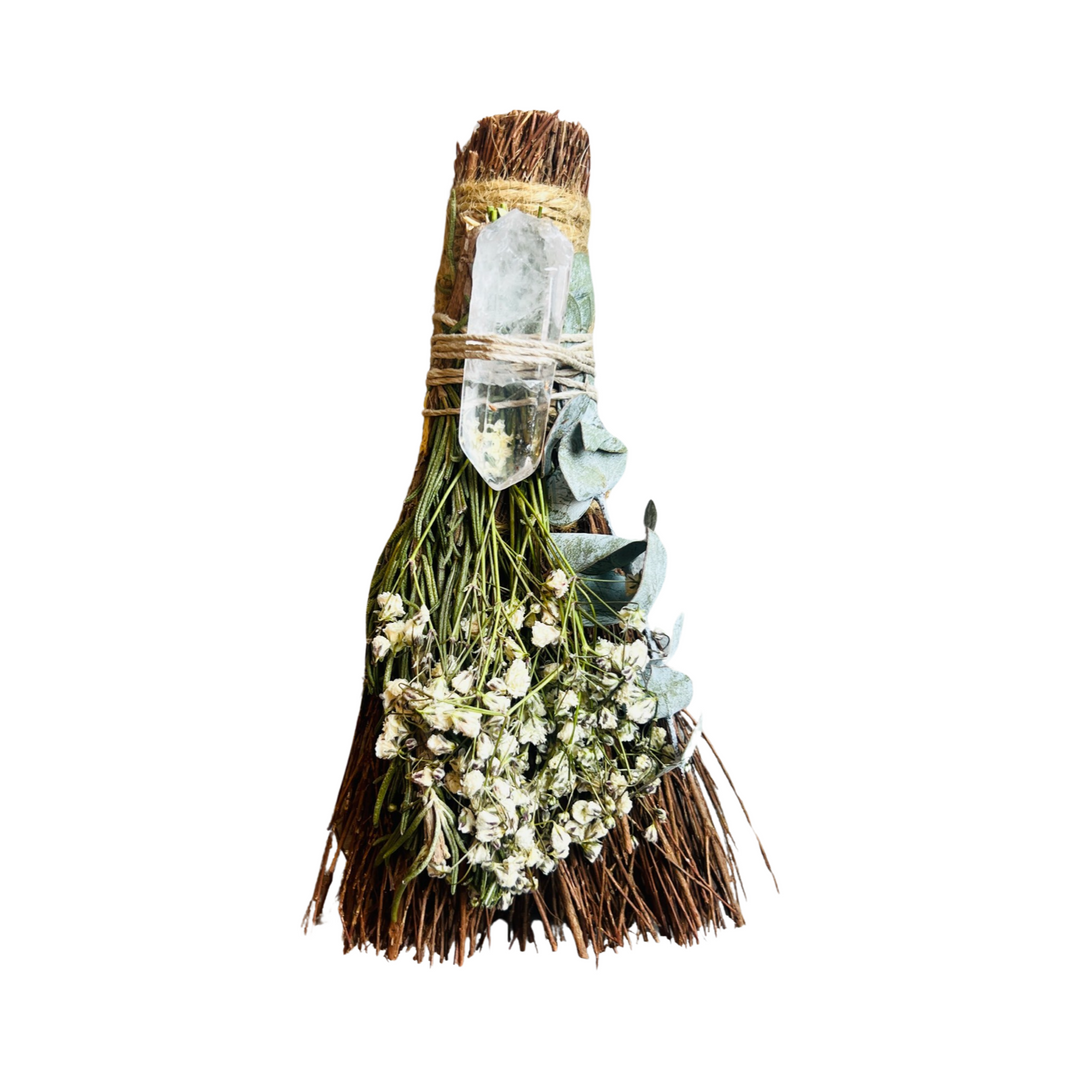 a cinnamon scented broom with eucalyptus, baby's breath, rosemary, & a clear quartz crystal