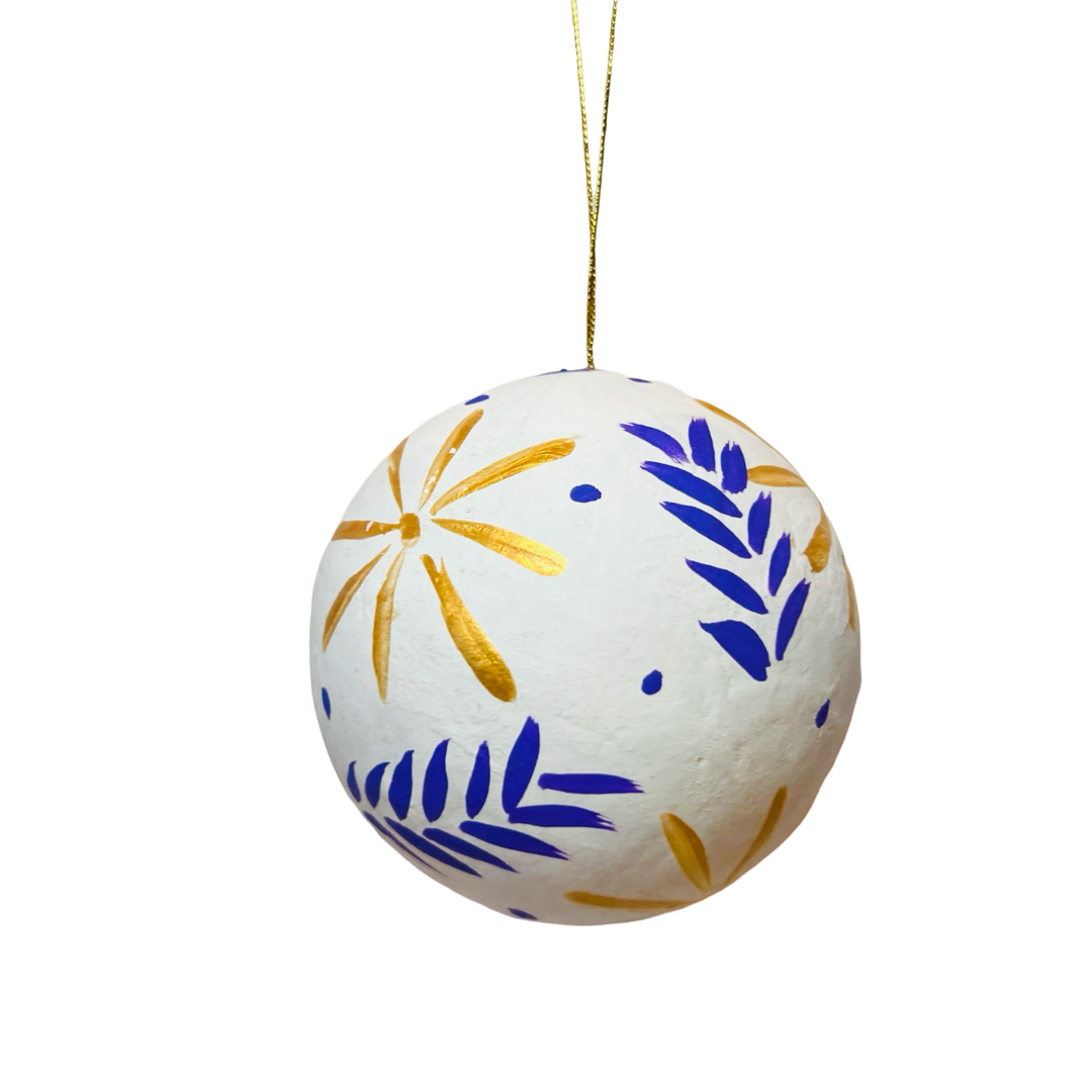 Hand-painted white papier-mâché sphere ornament featuring gold floral design