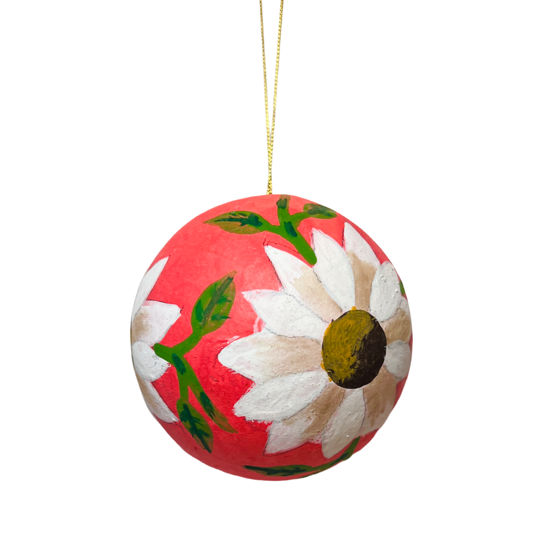 Hand-painted pink papier-mâché sphere ornament featuring white floral designs