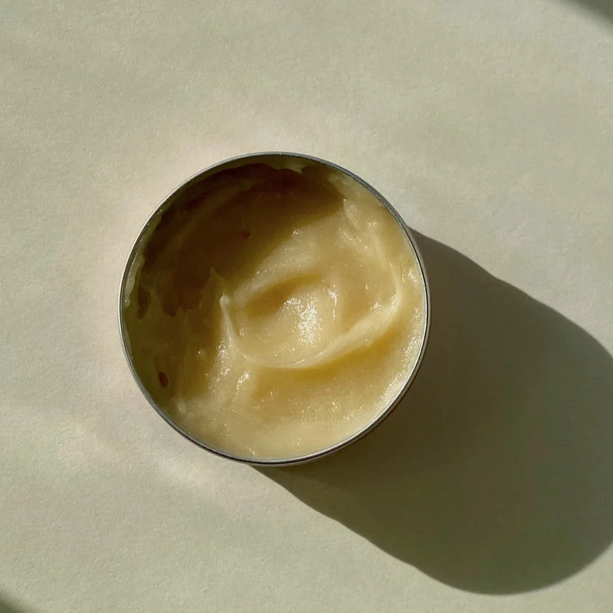 cream colored lip balm in a round vessel