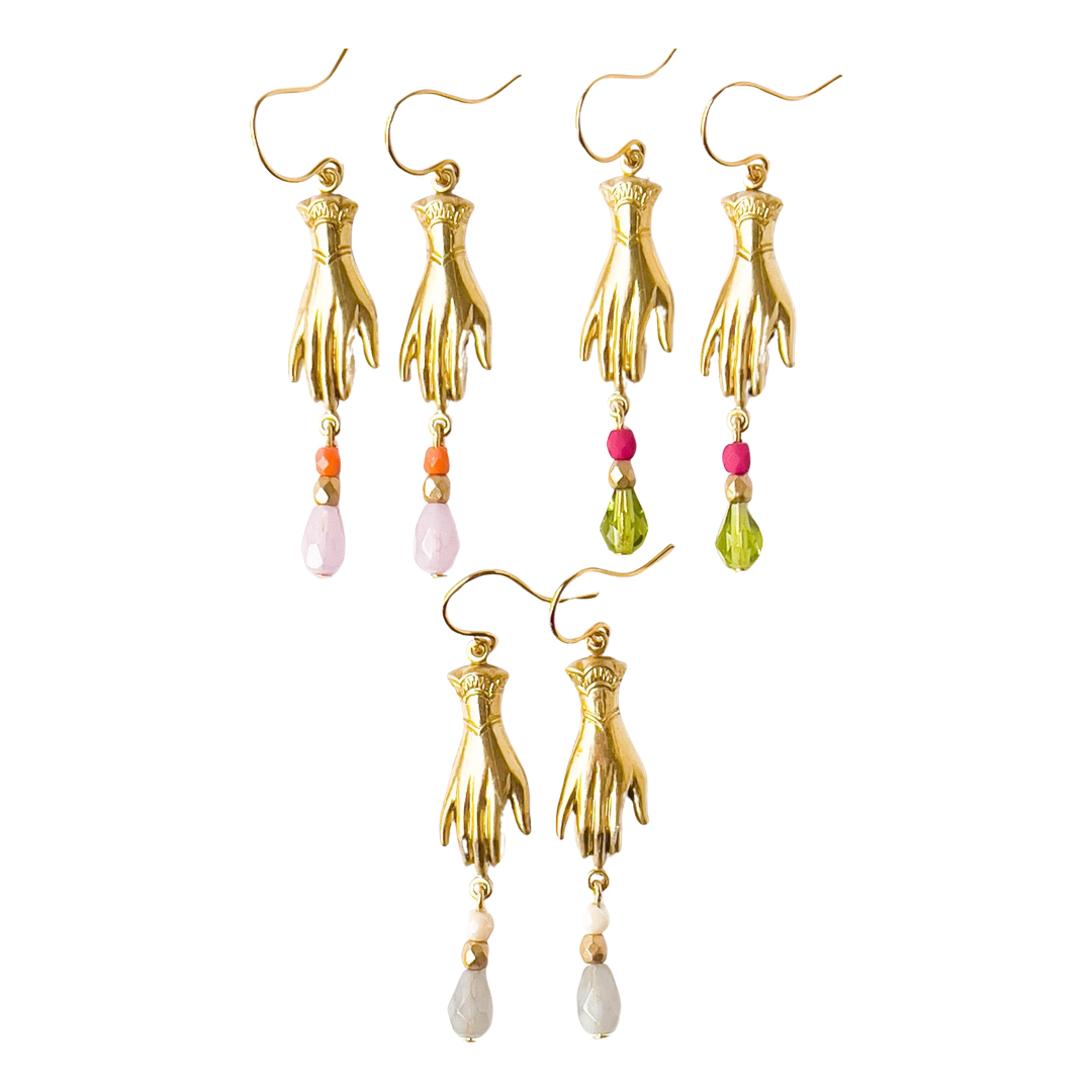 close up of three sets of earrings that feature a brass hand and 3 multi-colored Czech glass beads