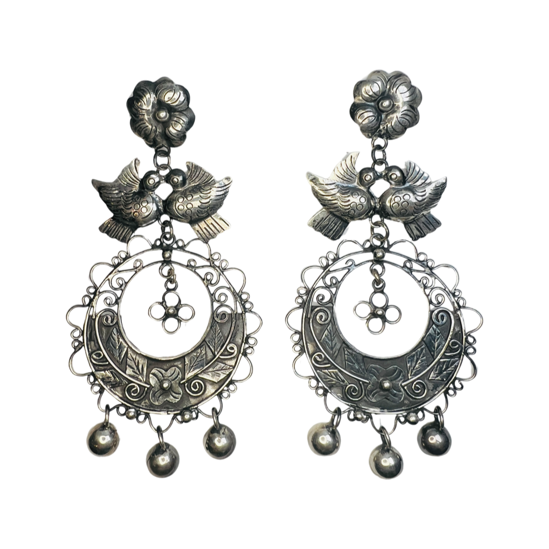 set of silver earrings that feature filigree details, two doves and a flower.