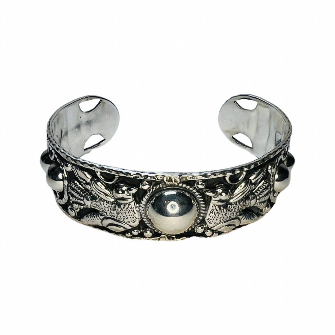 silver cuff bracelet that features a pair of doves