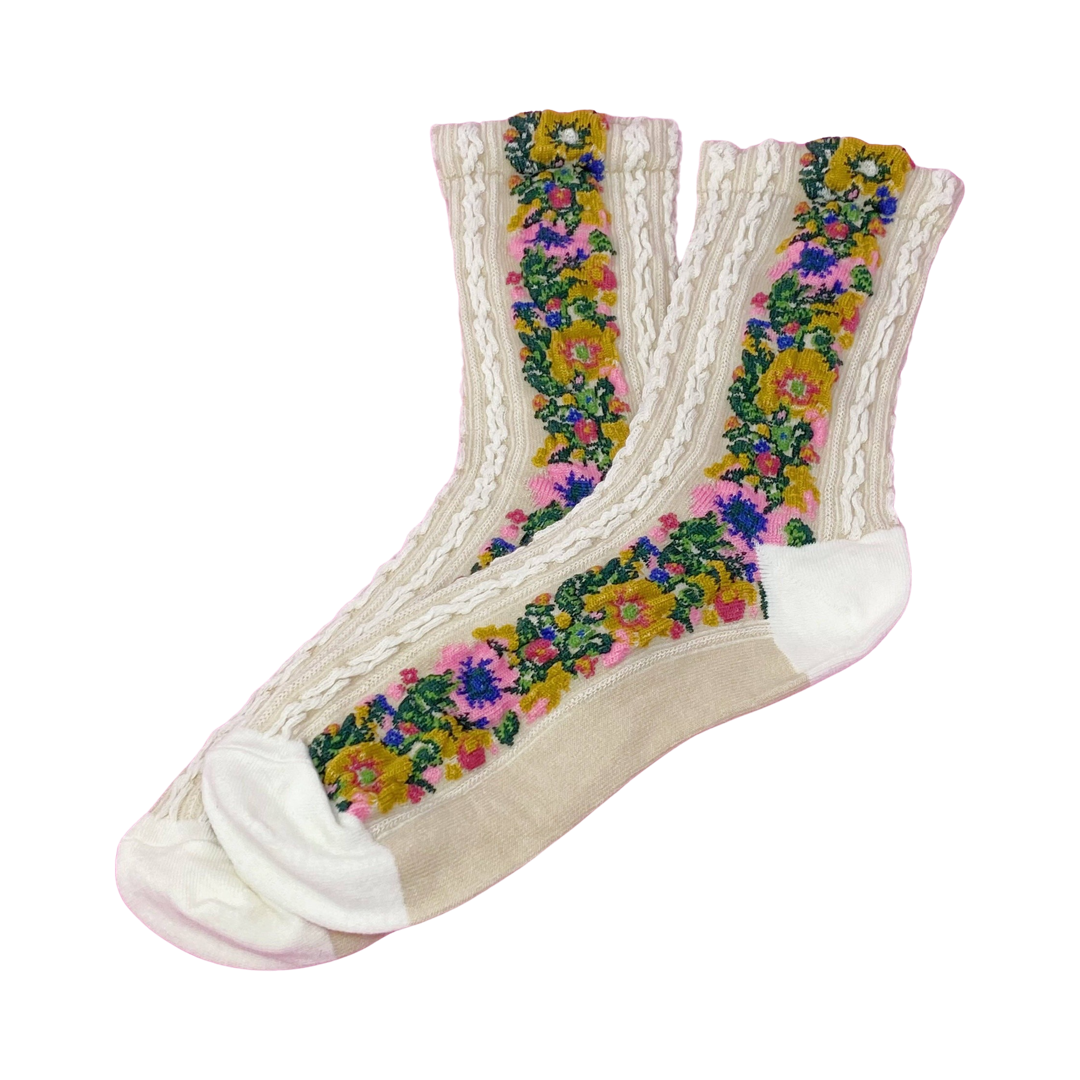 cream colored pair of socks with a knitted floral pattern on the side