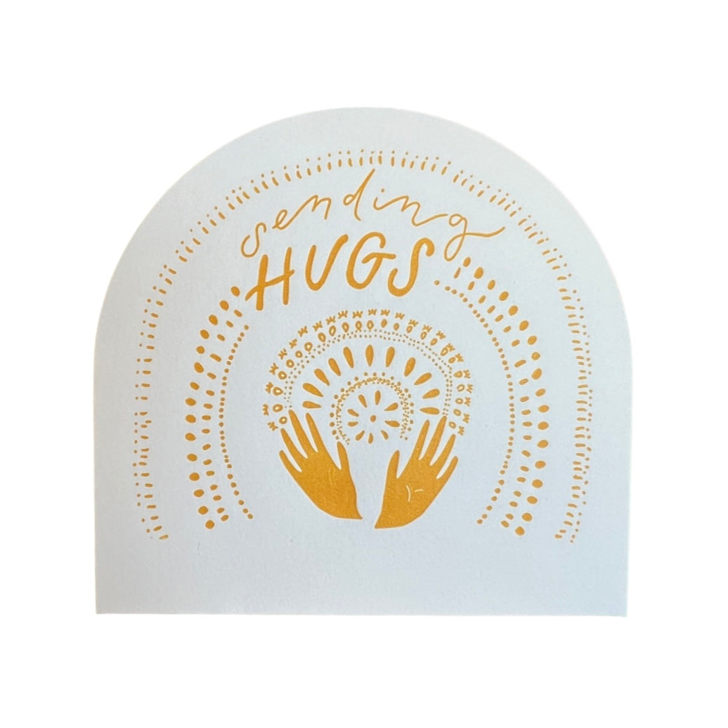 white half circle card with a gold dotted design with two hands and the phrase Sending Hugs